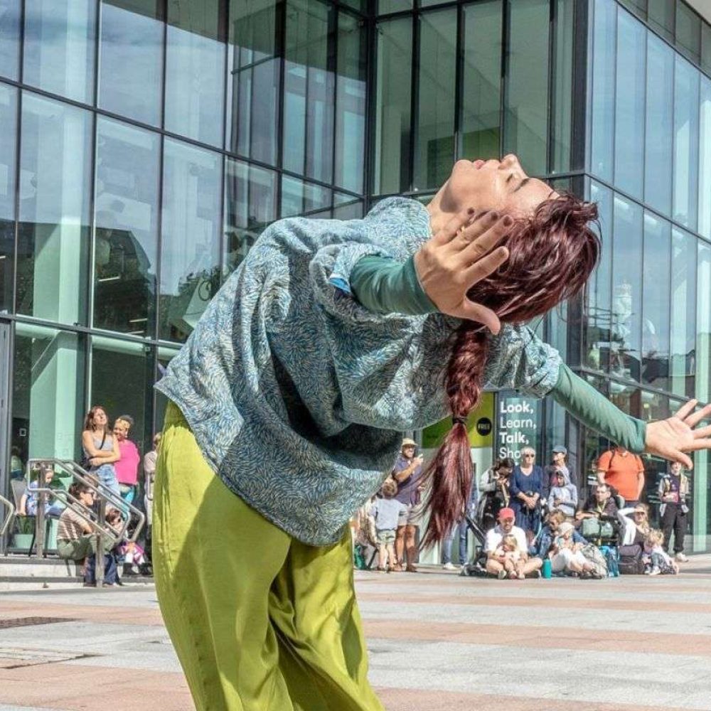 Woman dancing outside the box